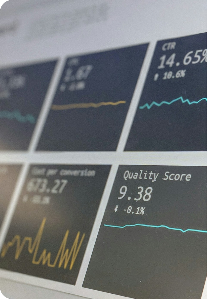 A close up image of a laptop screen with multiple cards showing graph analytics and numbers.
