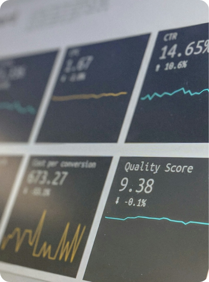 A close up image of a laptop screen with multiple cards showing graph analytics and numbers.
