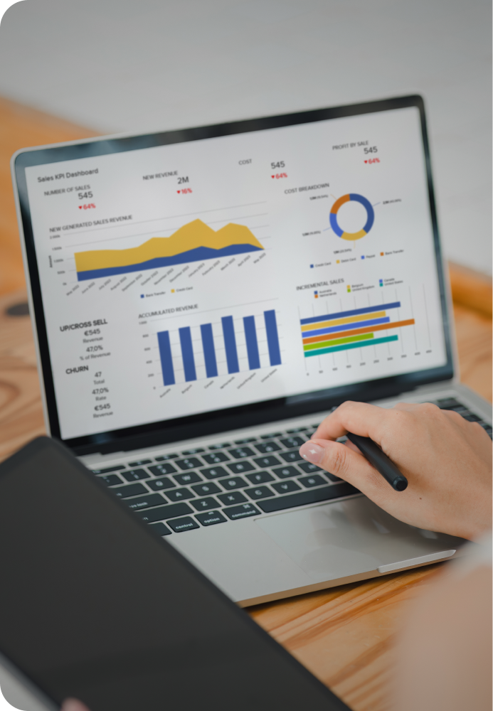 Image of a person/teammate working on their laptop, with charts & graphs outlining the potential dashboard of data.